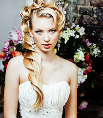 Image showing beauty young blond woman bride alone in luxury vintage interior with a lot of flowers 