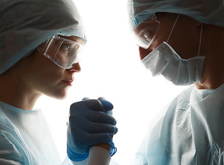 Image showing Doctors in gloves make handshake