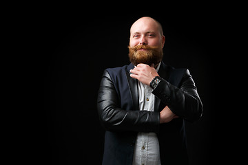 Image showing Pleased man stroking ginger beard