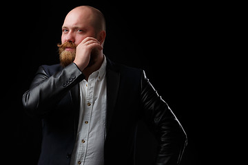 Image showing Man curls his ginger mustache