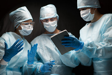 Image showing Doctors in operating with tablet