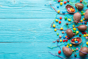 Image showing Chocolate eggs, colorful candy ,ribbons
