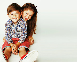 Image showing little cute boy and girl hugging playing on white background, ha