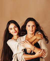 Image showing cute pretty teen daughter with mature mother hugging, fashion st