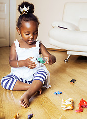 Image showing little cute african american girl playing with animal toys at ho