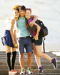 Image showing cute group of teenages at the building of university with books 