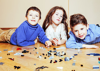 Image showing funny cute children playing toys at home, boys and girl smiling, first education role close up, lifestyle people concept