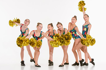 Image showing The group of teen cheerleaders posing at white studio