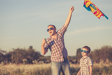 Image showing Father and son playing at the park at the sunset time.