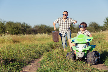 Image showing Father and son playing on the road at the day time.