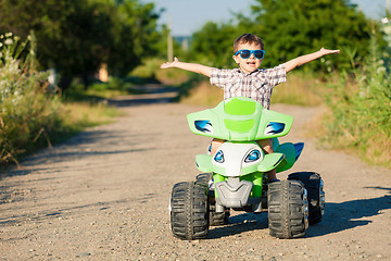 Image showing Happy little boy playing on road at the day time.