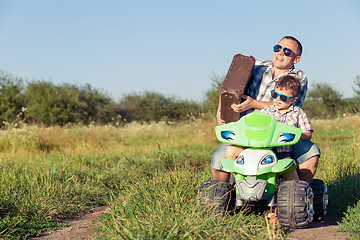 Image showing Father and son playing on the road at the day time.