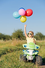 Image showing Happy little girl playing on road at the day time.