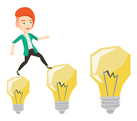 Image showing Business woman jumping on light bulbs.