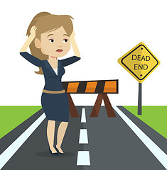 Image showing Business woman looking at road sign dead end.