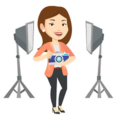 Image showing Photographer with camera in photo studio.