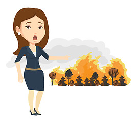 Image showing Woman standing on background of wildfire.