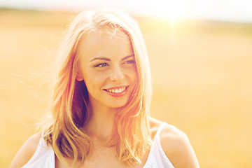 Image showing smiling young woman in white on cereal field