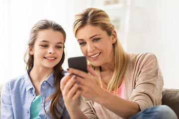 Image showing happy family with smartphone at home