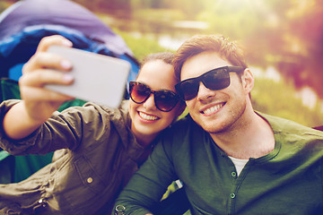 Image showing couple of travelers taking selfie by smartphone