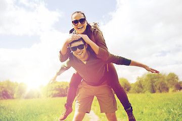 Image showing happy couple with backpacks having fun outdoors