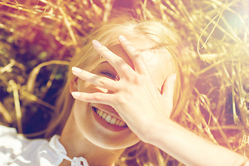 Image showing happy young woman lying on cereal field