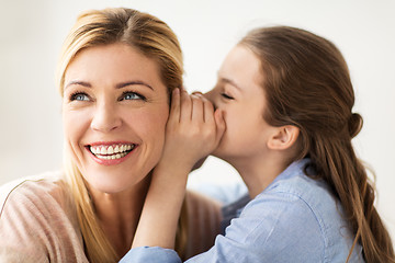 Image showing happy girl whispering secret to her mother