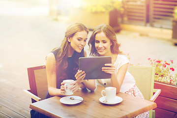 Image showing young women with tablet pc and coffee at cafe