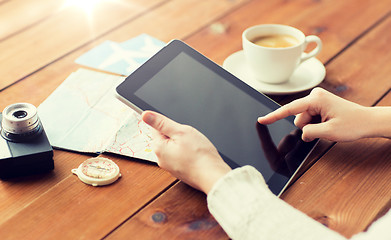 Image showing close up of traveler hands with tablet pc and map