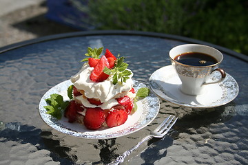 Image showing Pastry with strawberries and a cup of strong coffee