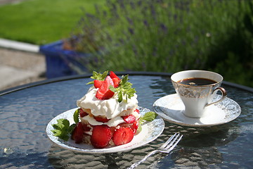 Image showing Pastry with sweet strawberries and a cup of strong coffee