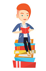 Image showing Student sitting on huge pile of books.