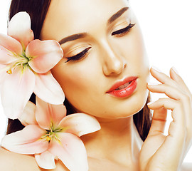 Image showing young attractive lady close up with hands on face isolated flowe