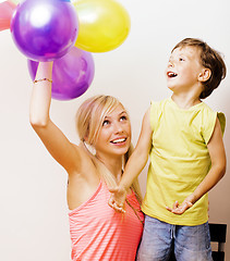 Image showing pretty real family with color balloons on white background, blon