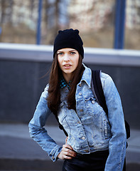 Image showing young pretty girl near business building walking