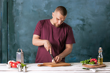 Image showing Closeup hand of chef baker making pizza at kitchen