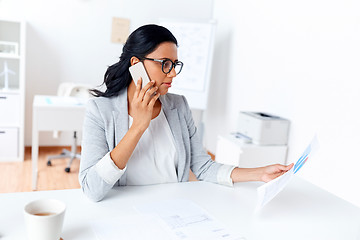 Image showing businesswoman calling on smartphone at office