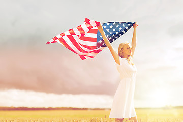 Image showing happy woman with american flag on cereal field