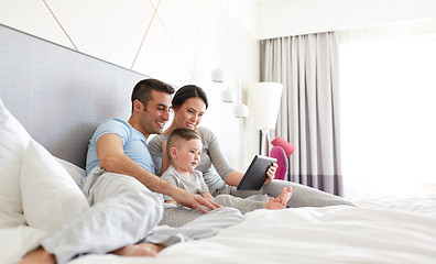 Image showing happy family with tablet pc in bed at home