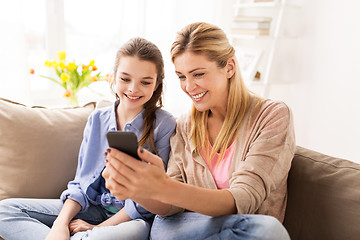 Image showing happy family with smartphone at home