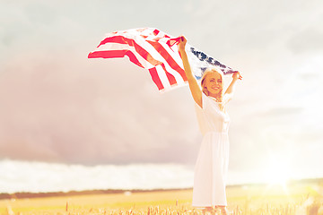 Image showing happy woman with american flag on cereal field