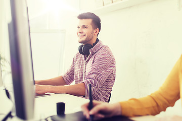 Image showing happy creative team with computer and pen tablet