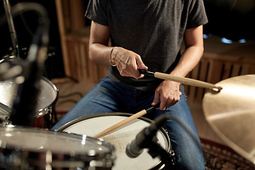 Image showing male musician playing drums and cymbals at concert