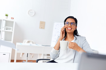 Image showing businesswoman calling on smartphone at office