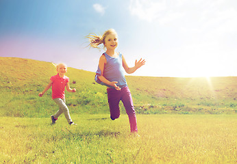 Image showing group of happy kids running outdoors