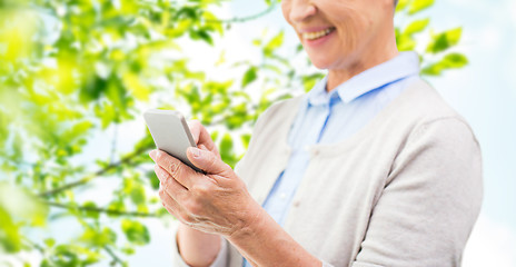 Image showing close up of senior woman with smartphone texting