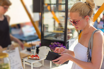 Image showing Woman buying meal at street food festival.