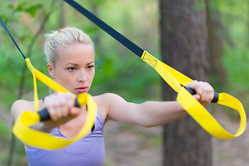 Image showing Training with fitness straps outdoors.