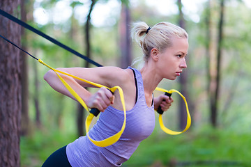 Image showing Training with fitness straps outdoors.