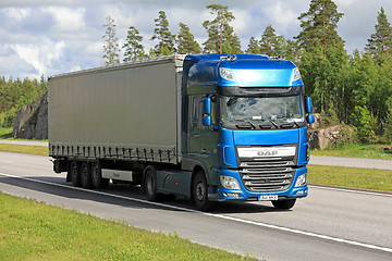 Image showing Blue DAF XF semi trailer road transport at summer